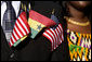 Flags of the United States and Ghana are displayed by a guest attending the South Lawn Arrival Ceremony for President John Agyekum Kufuor of Ghana Monday, Sept. 15, 2008, at the White House. White House photo by David Bohrer