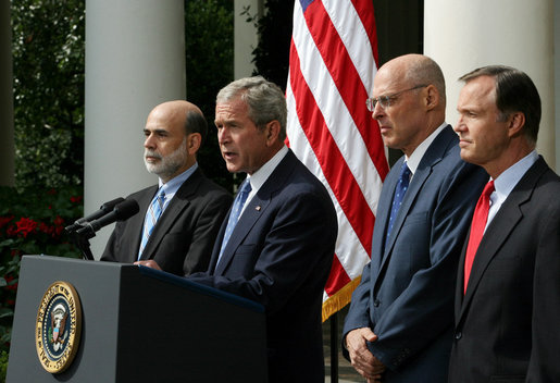 President George W. Bush stands with Federal Reserve Chairman Ben Bernanke, left, SEC Chairman Chris Cox, right, and Treasury Secretary Hank Paulson as he delivers a statement on the economy Friday, Sept. 19, 2008, in the Rose Garden of the White House. Said the President, "This is a pivotal moment for America's economy. We must act now to protect our nation's economic health from serious risk." White House photo by Joyce N. Boghosian
