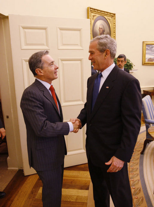 President George W. Bush welcomes Colombian President Alvaro Uribe into the Oval Office Saturday, Sept. 20, 2008, at the White House. White House photo by Eric Draper