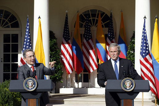President George W. Bush listens as Colombian President Alvaro Uribe speaks to a reporter Saturday, Sept. 20, 2008, during a joint press availability in the Rose Garden at the White House. White House photo by Eric Draper