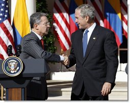 President George W. Bush shakes hands with Colombian President Alvaro Uribe following a joint press availability Saturday, Sept. 20, 2008, in the Rose Garden at the White House.  White House photo by Eric Draper