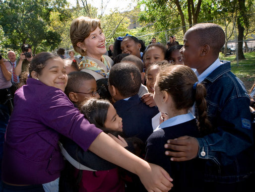 Mrs. Laura Bush receives a big group hug from children visiting from the Adam Clayton Powell Jr. Elementary School (P.S. 153) and the Boys and Girls Club of Harlem at the conclusion of a First Bloom program at the Hamilton Grange National Memorial in New York City, Sept. 24, 2008. The First Bloom program is a national conservation education program for the National Park Foundation that encourages young people to protect the environment in America's National Parks and in their own back yards. White House photo by Chris Greenberg