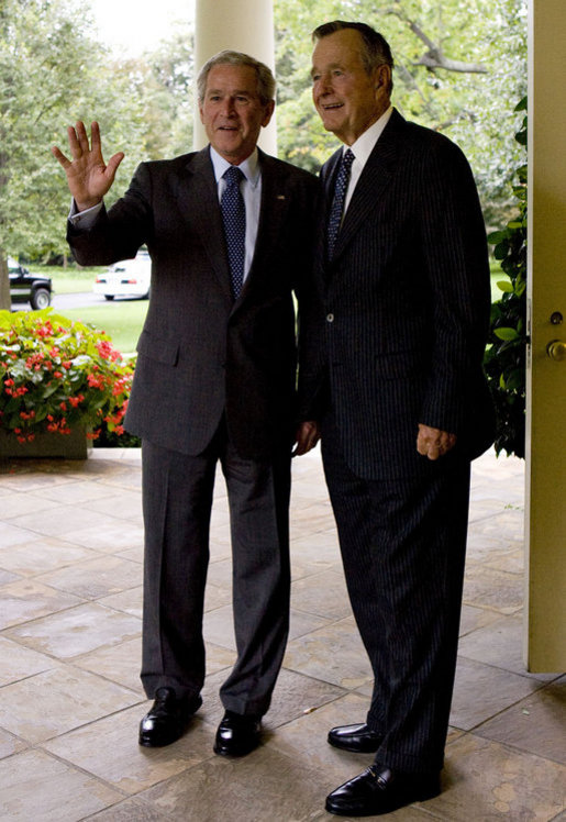 President George W. Bush and former President George H.W. Bush pause to acknowledge staff as they depart the Oval Office Thursday, Sept. 25, 2008, after the signing of S.3406, the ADA Amendments Act of 2008. White House photo by Joyce N. Boghosian
