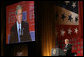 President George W. Bush is seen on a large video screen as he addresses his remarks to guests Wednesday evening, Oct. 1, 2008, at the United Services Organization World Gala in Washington, D.C. White House photo by Chris Greenberg