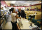 President George W. Bush greets an employee inside Olmos Pharmacy in San Antonio, Texas Monday, Oct. 6, 2008, where he greeted local citizens and met with business owners about the current economic climate. The Pharmacy was established in 1938 and while it no longer operates as a pharmacy, it has retained its original soda fountain and lunch counter. White House photo by Eric Draper
