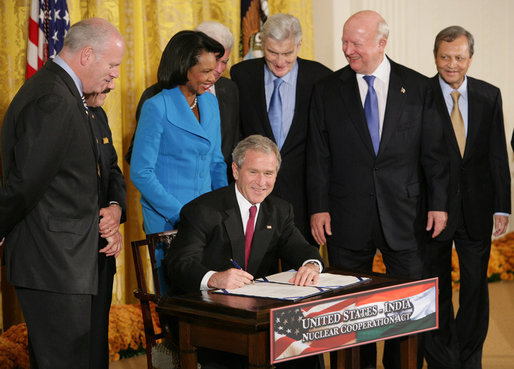 President George W. Bush signs H.R. 7081, The United States-India Nuclear Cooperation Approval and Nonproliferation Enhancement Act, Wednesday, Oct. 8, 2008, in the East Room at the White House. President Bush is joined on stage by, from left, Rep. Joseph Crowley, D-N.Y., Rep. Eliot Engel, D-N.Y., Secretary of State Condoleezza Rice, Sen. Chris Dodd, D-Conn., Senator John Warner of Virginia, Energy Secretary Samuel Bodman, and India's Ambassador to the United States Ronen Sen. White House photo by Chris Greenberg