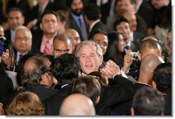 President George W. Bush reaches into the audience to shake hands after signing H.R. 7081, The United States-India Nuclear Cooperation Approval and Nonproliferation Enhancement Act, Wednesday, Oct. 8, 2008, in the East Room at the White House. White House photo by Chris Greenberg