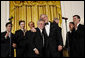 President George W. Bush, joined on stage by Italian Prime Minister Silvio Berlusconi, embraces singer Frankie Valli, lead singer of The Four Seasons, invited on stage Monday evening, Oct. 13, 2008, following a performance of the Broadway cast of the Jersey Boys in the East Room of the White House. White House photo by Eric Draper