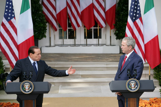 President George W. Bush listens as Italian Prime Minister Silvio Berlusconi addresses his remarks at a joint press availability Monday, Oct. 13, 2008, in the White House Rose Garden. Prime Minister Berlusconi said that Italy and America share a special friendship which has its roots in common values, in sharing a world which is inspired by love for democracy and freedom. White House photo by Chris Greenberg