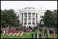 President George W. Bush and Prime Minister Silvio Berlusconi stand together on the reviewing stand Monday, Oct. 13, 2008 on the South Lawn of the White House, as the Old Guard Fife and Drum Corps passes in review during the arrival ceremony to welcome Prime Minister Berlusconi to the White House. White House photo by Chris Greenberg