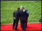 President George W. Bush is embraced by Prime Minister Silvio Berlusconi as he honors the Italian leader Monday, Oct. 13, 2008, during an official welcoming ceremony on the South Lawn of the White House. White House photo by Grant Miller