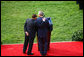 President George W. Bush is embraced by Prime Minister Silvio Berlusconi as he honors the Italian leader Monday, Oct. 13, 2008, during an official welcoming ceremony on the South Lawn of the White House. White House photo by Grant Miller
