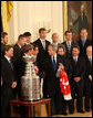 President George W. Bush thanks Detroit Red Wings player Chris Chelios for a miniature Stanley Cup presented to the President Tuesday, Oct. 14, 2008 in the East Room at the White House, during the ceremony to honor the Red Wings 2008 Stanley Cup championship. White House photo by Chris Greenberg