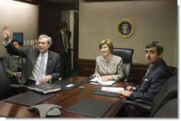 Mrs. Laura Bush acknowledges the Ladies in White during a video teleconference Thursday, Oct. 16, 2008, in the Situation Room of the White House. Mrs. Bush is joined by U.S. Secretary of Commerce Carlos Gutierrez, waving left, and interpreter Manuel Quiroz. Mrs. Laura Bush conveyed her continuous commitment, and that of the President, to support the Cuban people's aspirations for freedom.  White House photo by Joyce N. Boghosian