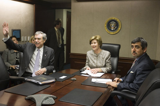 Mrs. Laura Bush acknowledges the Ladies in White during a video teleconference Thursday, Oct. 16, 2008, in the Situation Room of the White House. Mrs. Bush is joined by U.S. Secretary of Commerce Carlos Gutierrez, waving left, and interpreter Manuel Quiroz. Mrs. Laura Bush conveyed her continuous commitment, and that of the President, to support the Cuban people's aspirations for freedom. White House photo by Joyce N. Boghosian