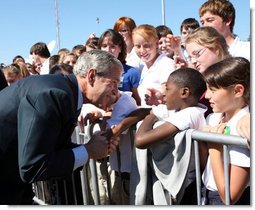 President George W. Bush shakes hands with a young boy as he arrives at Alexandria International Airport - Air National Guard Base Monday, Oct. 20, 2008, in Alexandria, Louisiana. White House photo by Chris Greenberg