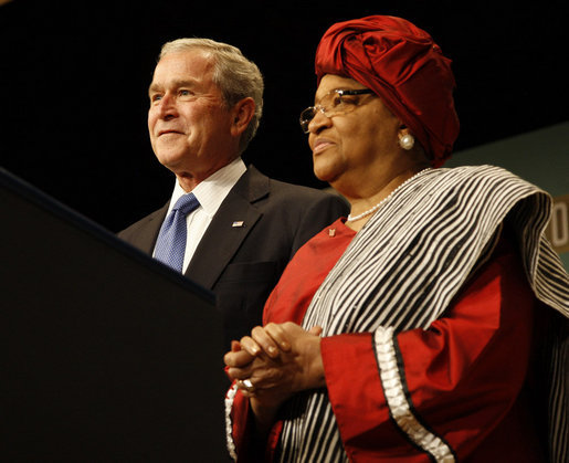 President George W. Bush stands with Liberian President Ellen Johnson Sirleaf before delivering his remarks at the White House Summit on International Development Tuesday, Oct. 21, 2008, in Washington, D.C. President Bush discussed in his remarks core transformational goals of country ownership, good governance, results-based programs and accountability, and the importance of economic growth. White House photo by Eric Draper