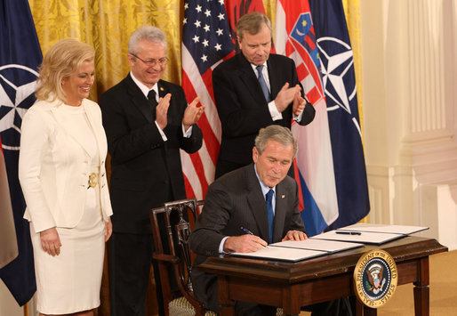 President George W. Bush is joined on stage by Croatian Ambassador to the U.S. Kolinda Grabar-Kitarovic, left, Albanian Ambassador to the U.S. Aleksander Saliabanda and NATO Secretary General Jaap De Hoop Scheffer, right, as he signs the NATO accession protocols Friday, Oct. 24, 2008 in the East Room of the White House, in support of the nations of Albania and Croatia to join the NATO alliance. When all 26 NATO allies have ratified the accession protocols Albania and Croatia will be eligible to join NATO. White House photo by Chris Greenberg