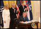 President George W. Bush is joined on stage by Croatian Ambassador to the U.S. Kolinda Grabar-Kitarovic, left, Albanian Ambassador to the U.S. Aleksander Saliabanda and NATO Secretary General Jaap De Hoop Scheffer, right, as he signs the NATO accession protocols Friday, Oct. 24, 2008 in the East Room of the White House, in support of the nations of Albania and Croatia to join the NATO alliance. When all 26 NATO allies have ratified the accession protocols Albania and Croatia will be eligible to join NATO. White House photo by Chris Greenberg
