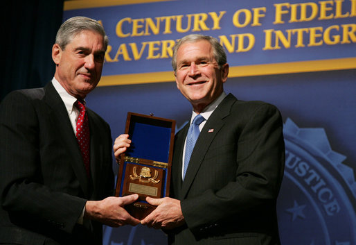 President George W. Bush is presented with an honorary FBI Special Agent credential by FBI Director Robert Mueller Thursday, Oct. 30, 2008, at the graduation ceremony for FBI special agents in Quantico, Va. White House photo by Joyce N. Boghosian