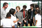 Surrounded by children participating in a soil sampling event, Mrs. Laura Bush speaks with Benjamin Jones, Director of Education, Trinity River Audubon Center, left during the First Bloom event at the Trinity River Audubon Center Sunday, November 2, 2008, in Dallas, TX. Mrs. Bush is joined by singer/songwriters the Jonas Brothers, Kevin Jonas, Joe Jonas, and Nick Jonas, right. White House photo by Chris Greenberg