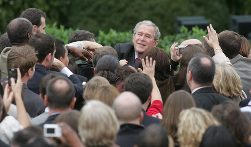 President George W. Bush reaches out to staff members of the Executive Office of the President Thursday, Nov. 6, 2008, after speaking to them on the upcoming presidential transition. The President was joined by his Cabinet, Vice President and Mrs. Cheney and Mrs. Laura Bush as he told his staff, "As January 20th draws near, some of you may be anxious about finding a new job, or a new place to live. But between now and then, we must keep our attention on the task at hand -- because the American people expect no less." White House photo by Joyce N. Boghosian