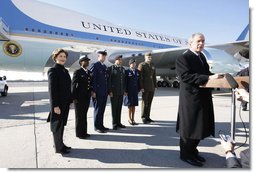 President George W. Bush, joined by Mrs. Laura Bush, stands outside Air Force One as he addresses his remarks in honor of Veterans Day, Tuesday, Nov. 11, 2008 upon the President's arrival at John F. Kennedy International Airport in New York. President Bush introduced military personnel representing the five branches of the armed services, who traveled with him aboard AF-1, honoring their service, from left are, U.S. Navy Chief Petty Officer Shenequa Cox of Dallas, Texas; U.S. Coast Guard Petty Officer First Class Christopher O. Hutto of Homer, Alaska; U.S. Army National Guard SSgt Michael Noyce-Merino of Melrose, Montana; U.S. Air Force Senior Airman Alicia Goetschel of Warrensburg, Mo., and U.S. Marine Corps Sgt. John Badon of Lufkin, Texas.  White House photo by Eric Draper