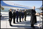 President George W. Bush, joined by Mrs. Laura Bush, stands outside Air Force One as he addresses his remarks in honor of Veterans Day, Tuesday, Nov. 11, 2008 upon the President's arrival at John F. Kennedy International Airport in New York. President Bush introduced military personnel representing the five branches of the armed services, who traveled with him aboard AF-1, honoring their service, from left are, U.S. Navy Chief Petty Officer Shenequa Cox of Dallas, Texas; U.S. Coast Guard Petty Officer First Class Christopher O. Hutto of Homer, Alaska; U.S. Army National Guard SSgt Michael Noyce-Merino of Melrose, Montana; U.S. Air Force Senior Airman Alicia Goetschel of Warrensburg, Mo., and U.S. Marine Corps Sgt. John Badon of Lufkin, Texas. White House photo by Eric Draper