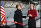 Mrs. Laura Bush and Sally Hoover Casale, daughter of the late U.S. Navy aviator Captain William 'Bill' H. Hoover, complete the ribbon cutting Tuesday, Nov. 11, 2008, to release a bottle for the re-christening of the USS Intrepid, during the rededication ceremony for the Intrepid Sea, Air and Space Museum in New York. White House photo by Chris Greenberg