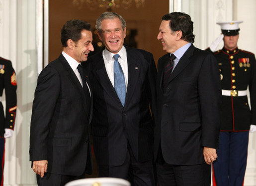 President George W. Bush offers a warm welcome to President of France Nicolas Sarkozy, left, and European Commission President Jose Manuel Barroso, right, Friday, Nov. 11, 2008, upon their arrival for a dinner to open the Summit on Financial Markets and World Economy at the White House. White House photo by Chris Greenberg