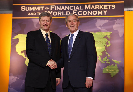President George W. Bush welcomes Canadian Prime Minister Stephen Harper to the Summit on Financial Markets and the World Economy Saturday, Nov. 15, 2008, at the National Building Museum in Washington, D.C. White House photo by Chris Greenberg