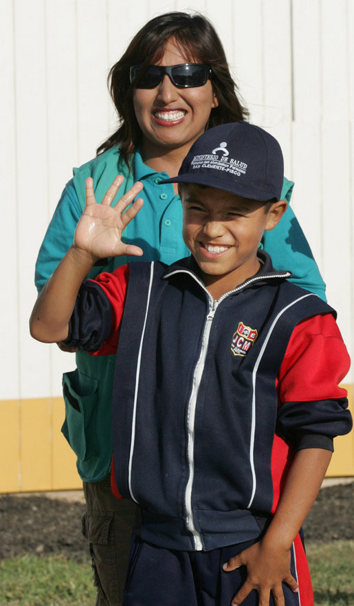 A very proud 8-year-old William Sebastian Hernandez Jeri holds up his hand to show how clean it is after demonstrating hand-washing techniques Friday, Nov. 21, 2008, for Mrs. Laura Bush at the San Clemente Health Center in San Clemente, Peru. Looking on is Ms. Nancy Quispitupa, Program Manager and Community Trainer. White House photo by Joyce N. Boghosian