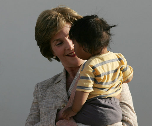 Mrs. Laura Bush smiles as she holds a child during a visit Friday, Nov. 21, 2008, to the San Clemente Health Center in San Clemente, Peru. The center serves an average of 80 patients a day in the town of 25,000 located six miles north of Pisco, the site of the August 2007, 8.0-magnitude earthquake. White House photo by Joyce N. Boghosian