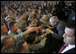 President George W. Bush greets his audience Tuesday, Nov. 25, 2008, after addressing the troops at Fort Campbell, Ky. Said the President, "I'm honored to be with the Screaming Eagles of the 101st Airborne; the Night Stalkers of the 160th; the Green Berets of the 5th Special Forces Group, all members of the Fort Campbell community. You are part of the finest military in the world. I have one word for you: Hooah!" White House photo by Eric Draper