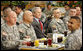 President George W. Bush is flanked by Sgt. First Class Rick Elza, left, of Lexington, Ky., and Capt. Rolando Perez of Mayaguez, Puerto Rico, as he sits for lunch Tuesday, Nov. 25, 2008, at Fort Campbell's Son Cafe. White House photo by Eric Draper
