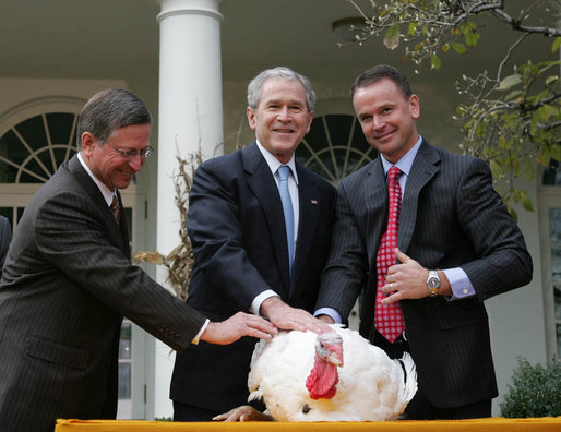 President George W. Bush stands between Paul Hill, left, of the National Turkey Federation, and his son, Nathan Hill during the pardoning of the Thanksgiving turkey Wednesday, Nov. 26, 2008, in the Rose Garden of the White House. This year marked the 61st anniversary of the National Thanksgiving Turkey Presentation and Pardoning. White House photo by Joyce N. Boghosian