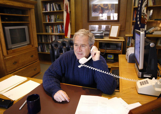 President George W. Bush talks to military personnel from Camp David, Thanksgiving Day, Thursday, Nov. 27, 2008. The President called members of the Armed Forces stationed in remote locations worldwide to wish them a happy Thanksgiving and thank them for their service to our nation. White House photo by Eric Draper