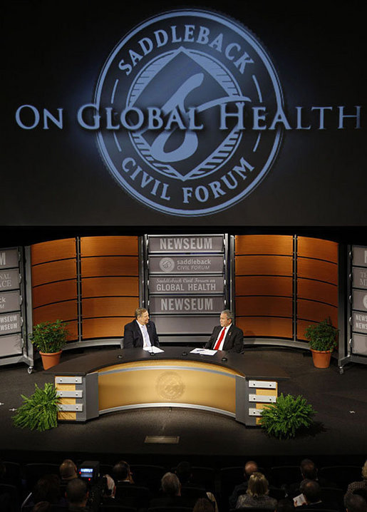 President George W. Bush speaks with Pastor Rick Warren Monday, Dec. 1, 2008, during President Bush's participation at the Saddleback Civil Forum on Global Health at the Newseum in Washington, D.C. White House photo by Eric Draper
