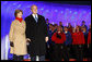 President George W. Bush and Mrs. Laura Bush join the Enterprise High School Encores from Enterprise, Ala., on stage at the Ellipse Thursday, Dec. 4, 2008, during the Lighting of the National Christmas Tree in Washington, D.C. White House photo by Eric Draper