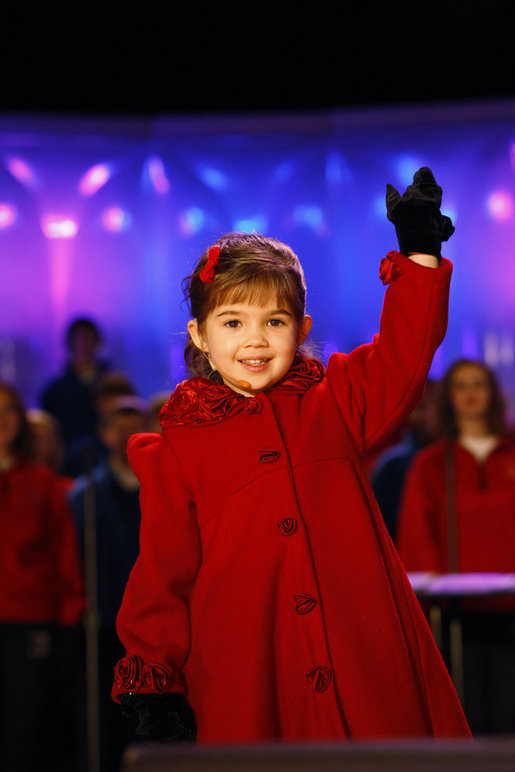 Four-year-old singer Kaitlyn Maher waves to the crowd during her performance Thursday, Dec. 4, 2008, at the Ellipse in Washington, D.C., for the annual Lighting of the National Christmas Tree. White House photo by Eric Draper