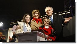 President George W. Bush and Mrs. Laura Bush are joined by tree lighters Kayleigh Kepler, 11, left, and Lindsey Van Horn, 9, during the 2008 Lighting of the National Christmas Tree Thursday, Dec. 4, 2008, on the Ellipse in Washington, D.C.  White House photo by Eric Draper
