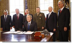 President George W. Bush smiles after signing the Presidential proclamation designating the World War II Valor in the Pacific National Monument and the Presidential proclamation in honor of National Pearl Harbor Remembrance Day 2008 in the Oval Office of the White House. With him for the signing Friday, Dec. 5, 2008, are from left: Pearl Harbor Survivor Jay Groff; George Sullivan, Chairman, Arizona Memorial Museum Association; Secretary Donald Winter, U.S. Department of the Navy; Gen. James "Hoss" Cartwright, Vice Chairman, Joint Chiefs of Staff; Secretary James Peake, U.S. Department of Veterans Affairs, and Secretary Dirk Kempthorne, U.S. Department of the Interior.  White House photo by Eric Draper