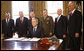 President George W. Bush smiles after signing the Presidential proclamation designating the World War II Valor in the Pacific National Monument and the Presidential proclamation in honor of National Pearl Harbor Remembrance Day 2008 in the Oval Office of the White House. With him for the signing Friday, Dec. 5, 2008, are from left: Pearl Harbor Survivor Jay Groff; George Sullivan, Chairman, Arizona Memorial Museum Association; Secretary Donald Winter, U.S. Department of the Navy; Gen. James "Hoss" Cartwright, Vice Chairman, Joint Chiefs of Staff; Secretary James Peake, U.S. Department of Veterans Affairs, and Secretary Dirk Kempthorne, U.S. Department of the Interior. White House photo by Eric Draper