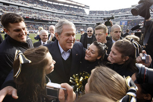 President George W. Bush is swarmed by the Army cheerleading squad Saturday, Dec. 8, 2008, on the field at Lincoln Financial Field in Philadelphia, for the 2008 Army-Navy game. White House photo by Eric Draper