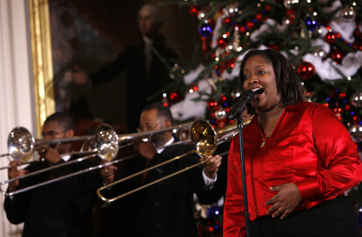 A vocalist with Sweet Heaven Kings entertains in the East Room of the White House Monday, Dec. 8, 2008, during the 2008 Children's Holiday Reception and Performance hosted by President George W. Bush and Mrs. Laura Bush. The Sweet Heaven Kings is the premier brass band at the United House of Prayer in Anacostia, Washington, D.C. White House photo by Eric Draper