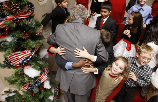 President George W. Bush is smothered in little hands as he says goodbye to a group of childen in attendance Monday, Dec. 8, 2008, for the Children's Holiday Reception and Performance at the White House. The President and Mrs. Laura Bush traditionally invite children to a White House celebration for the holidays, and this year, the audience included kids of active duty and reserve military service members from Russell Elementary at Quantico Marine Base, Dahlgren School at Dahlgren Navy Base and West Meade Elementary at Ft. Meade Army Base. White House photo by Eric Draper