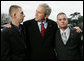 President George W. Bush pauses to greet Marine Lance Cpl. Patrick Paul Pittman Jr., left, and Lance Cpl. Marc E. Olson, both wounded in Operation Iraqi Freedom, as he arrived on the South Lawn of the White House Tuesday, Dec. 9, 2008, after spending the day at West Point. The Marines were on hand to greet the President upon his return.  White House photo by Joyce N. Boghosian