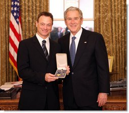 President George W. Bush stands with Gary Sinise after presenting him with the 2008 Presidential Citizens Medal Wednesday, Dec. 10, 2008, in the Oval Office of the White House. White House photo by Chris Greenberg