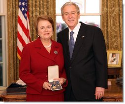 President George W. Bush stands with Dr. Anne M. Radice after presenting her with the 2008 Presidential Citizens Medal Wednesday, Dec. 10, 2008, in the Oval Office of the White House. White House photo by Chris Greenberg