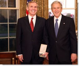 President George W. Bush stands with Raymond "Ray" Chambers after presenting him with the 2008 Presidential Citizens Medal Wednesday, Dec. 10, 2008, in the Oval Office of the White House. White House photo by Chris Greenberg